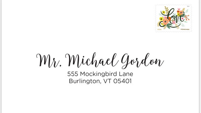 Wedding envelope with a guest name printed in calligraphy and a floral Love stamp